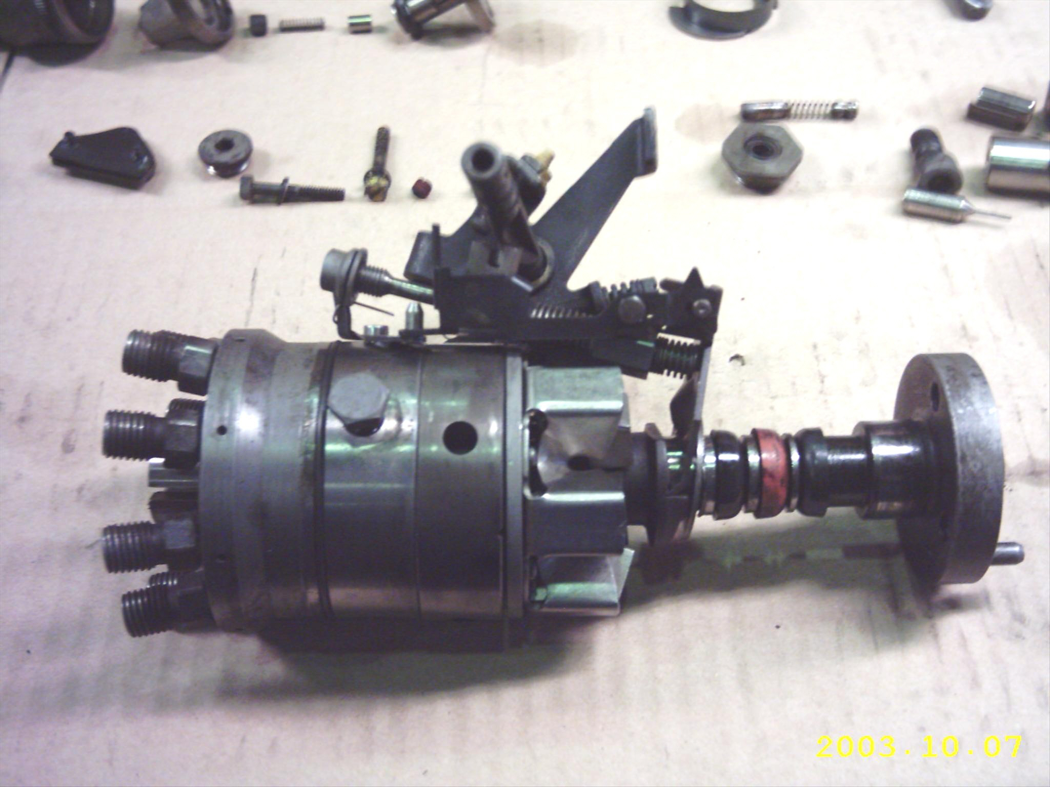 Hydraulic head with throttle linkage attached (at top) and drive shaft engage (right)