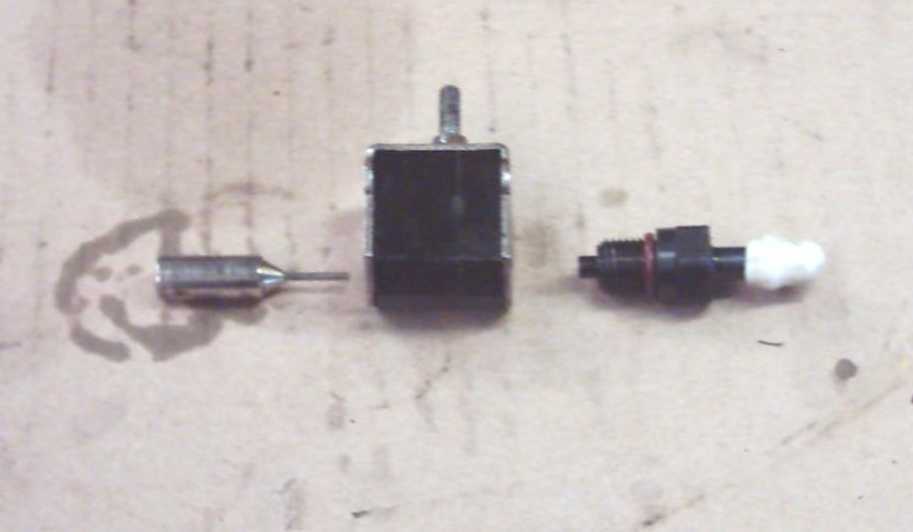 Picture of HPCA comprising: check valve solenoid needle (left), solenoid body and check valve (on right)