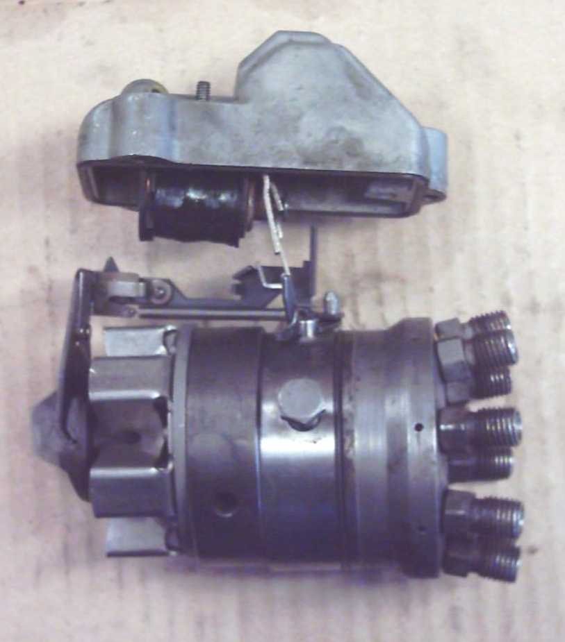 Shutoff solenoid in housing (top) engaging the shutoff rack on top the hydraulic head.  To the left of the hydraulic head is the governor assembly